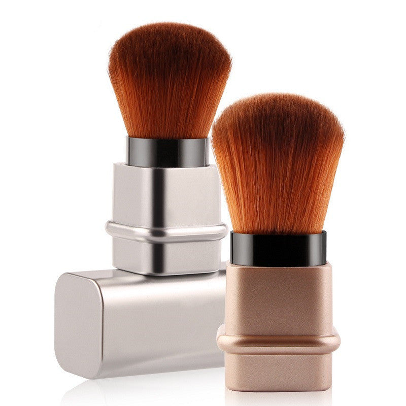 Portable single makeup brush with plastic handle and man-made fiber bristles in gold and silver colors