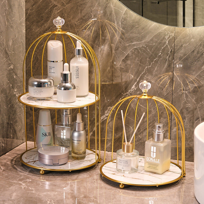 Vintage metal bathroom bird cage organizer with multi-tier shelves for makeup and skincare storage on vanity countertop